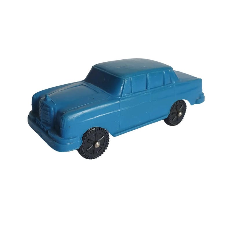 Puede incluir: Un coche de juguete azul con ruedas negras. El sed&aacute;n cl&aacute;sico presenta una parrilla delantera detallada y una carrocer&iacute;a aerodin&aacute;mica. Este coche de juguete vintage es un art&iacute;culo nost&aacute;lgico.