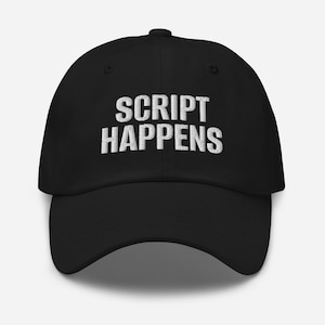 May include: Black baseball cap featuring the embroidered words "SCRIPT HAPPENS" in white. The cap has a curved peak and a structured crown. A casual accessory.