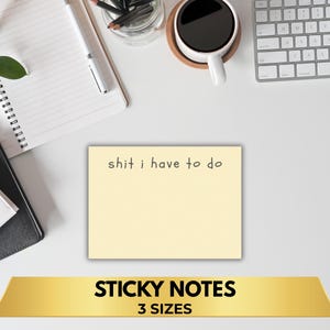 May include: A light yellow sticky note with the text "shit i have to do" in black. The image also includes a gold banner that reads "STICKY NOTES" and "3 SIZES". The background includes a notebook, pen, coffee cup, and keyboard.