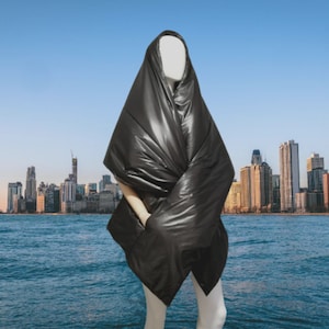 Hooded quilted black cape with pockets. Large puffer sleeveless cloak. Extravagant winter poncho. Futuristic padded coat unisex.