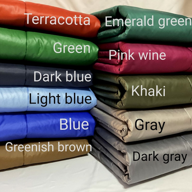 May include: A stack of fabric swatches in various colors, including terracotta, emerald green, green, pink wine, dark blue, khaki, light blue, blue, greenish brown, gray, and dark gray.