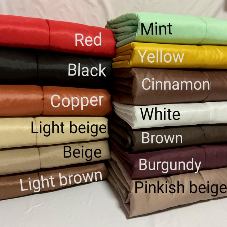 May include: A stack of fabric swatches in various colors, including mint, red, yellow, black, cinnamon, copper, white, light beige, beige, light brown, burgundy, and pinkish beige.