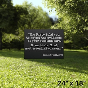May include: A black sign with white text quoting George Orwell: "The Party told you to reject the evidence of your eyes and ears. It was their final, most essential command." The sign is 61cm x 46cm and is displayed on a metal stake in a grassy area.