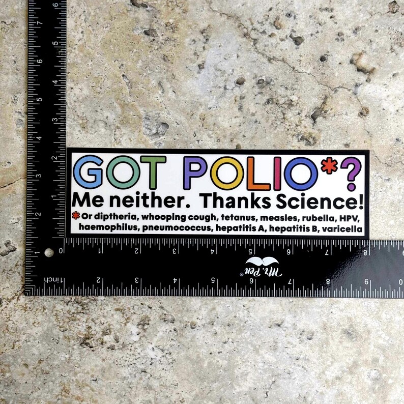 May include: A rectangular sticker with the text "GOT POLIO*? Me neither. Thanks Science!" in colorful letters. Below, it lists diseases like diphtheria, whooping cough, and measles. The sticker is placed on a textured, light-colored surface.