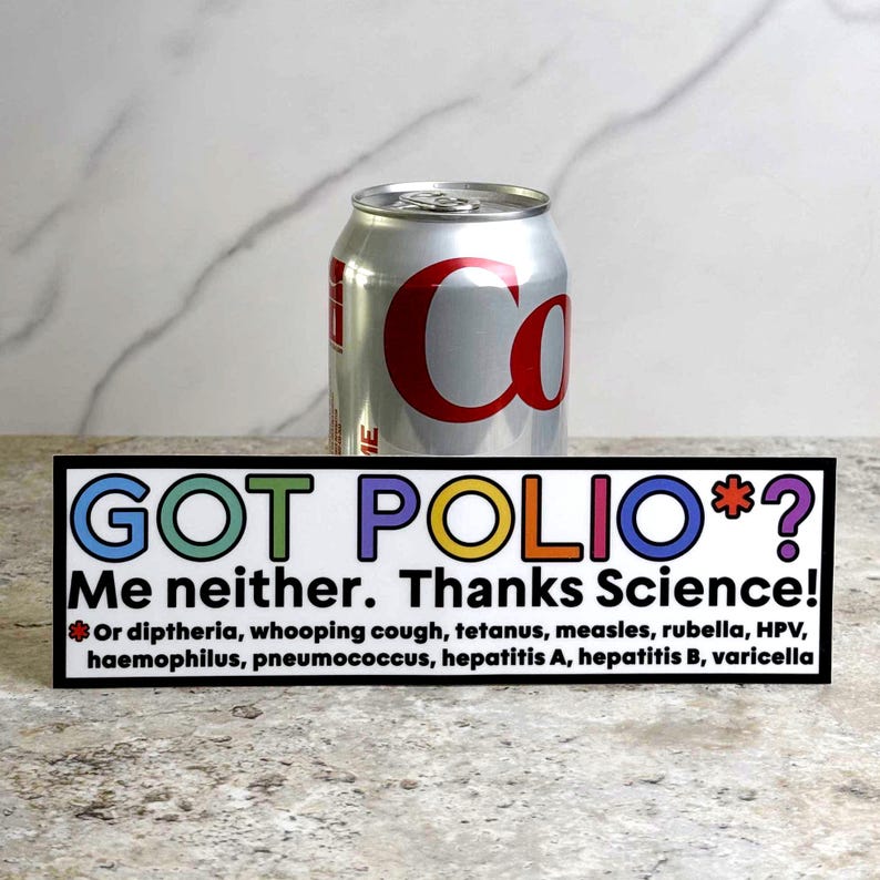 May include: A silver can of Coca-Cola stands behind a black and white sign. The sign reads "GOT POLIO*? Me neither. Thanks Science!" with a list of diseases below. The text is in various colors.