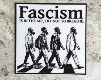 May include: Black and white square sticker featuring four figures wearing gas masks, walking across a crosswalk. The text "Fascism IS IN THE AIR, TRY NOT TO BREATHE" is printed above the figures in bold, black letters.