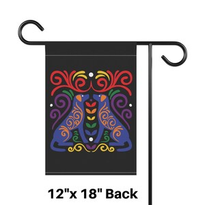 May include: A 12" x 18" garden flag with a black background and a colorful design of two dogs facing each other. The dogs are blue with yellow, orange, red, green, and purple accents. The design is surrounded by swirls and dots.