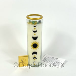 A set of eight glass candles with mystical designs on front and crystals on top.