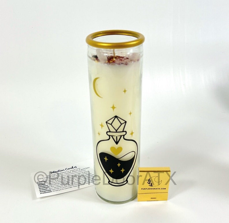 A set of eight glass candles with mystical designs on front and crystals on top.