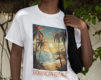 May include: White t-shirt featuring a graphic print of a beach scene with palm trees and the text "DOMINICAN REPUBLIC".