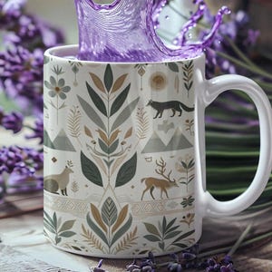 May include: A white ceramic mug with a nature-themed design, featuring illustrations of animals, mountains, and foliage in muted tones. A splash of purple liquid erupts from the mug, creating a dynamic visual. The mug is set on a wooden surface.