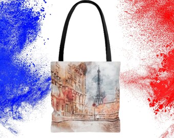 Könnte beinhalten: Eine Tragetasche mit einem Aquarellbild des Eiffelturms und einer Pariser Straßenszene. Die Tasche hat schwarze Henkel und einen weißen Canvas-Korpus.
