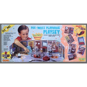 May include: A vintage Matchbox Pee-Wee's Playhouse Playset box. The box features a child interacting with the playset, which includes miniature figures and a scooter. The text on the box reads "Pee-Wee's Playhouse Playset."