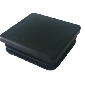 May include: Black plastic square end cap for furniture legs.