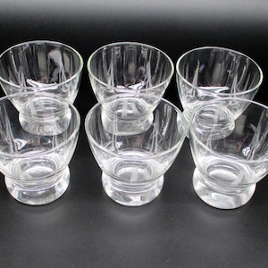 May include: Six clear glass bowls with a fluted design. The bowls are stacked in two rows of three.