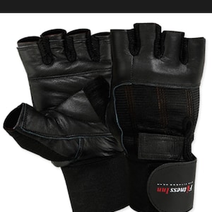 May include: Black weightlifting gloves with fingerless design. Features include a wrist strap and padded palm for grip. The brand name "Fitness Inn" is printed on the wrist strap.