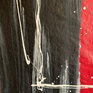 Puede incluir: Pintura abstracta con salpicaduras y rayas de pintura negra, blanca y roja sobre un lienzo.