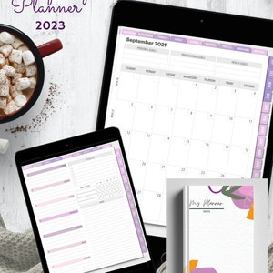 Peut inclure: Un planificateur numérique avec un thème de couleur violet et rose. Le planificateur comprend un calendrier, une liste de tâches et une section de notes. Le planificateur est intitulé "Prosperity Planner 2023" et "Version 2.0".