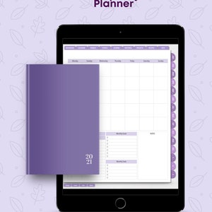 May include: A digital planner with a lavender cover and the text "Prosperity Planner" on the screen. The planner is open to a monthly calendar view with the year 2021 displayed. The planner also includes sections for goals, tasks, and notes.