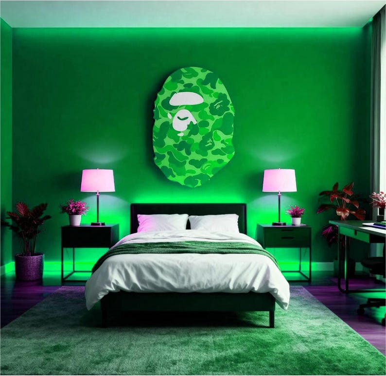 May include: A bedroom decorated in shades of green, featuring a large camouflage-patterned wall art. The room includes a bed with white bedding, two black bedside tables with pink lamps, and a green rug. The walls are painted a vivid green.