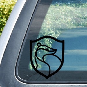 May include: Black and white vinyl sticker of a badger in a shield. The sticker is on a car window.