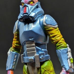 Bossk 1 of 1 by Tiddy Bean Toys. Hand molded, cast and painted. 2 points of articulation. UV reactive.