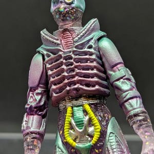 Shadow Minister (airbrushed) by Tiddy Bean Toys X Terrible Toyworks. 1 of 1. Hand cast and painted, UV reactive. 3 points of articulation.