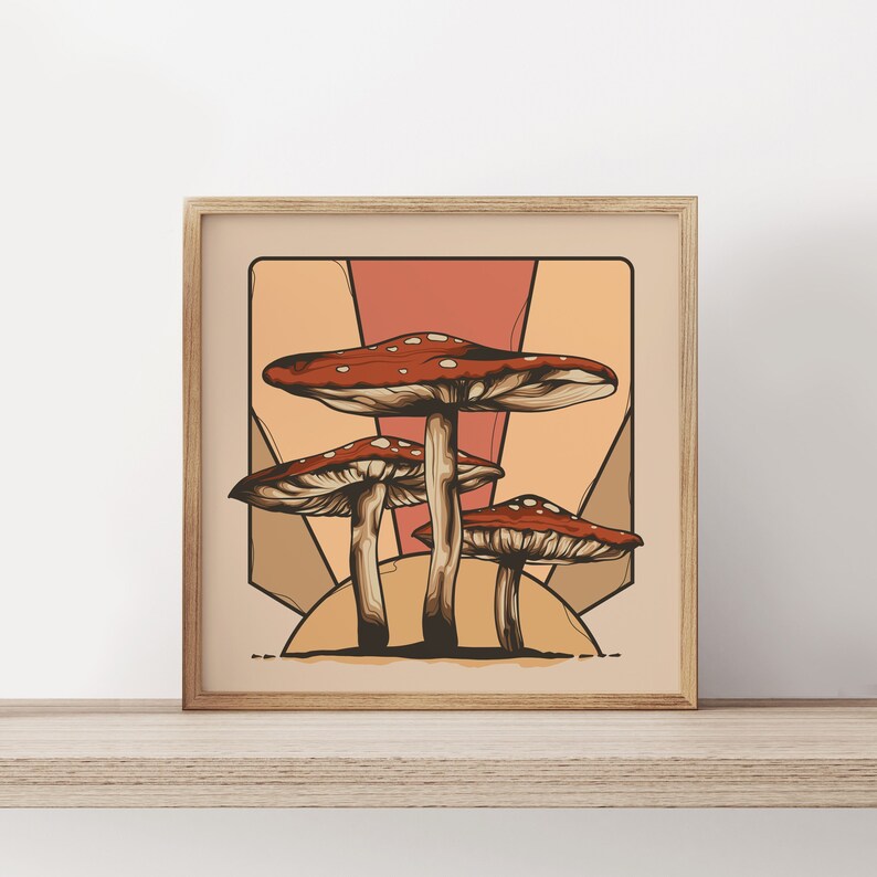 May include: A framed illustration of three red and white mushrooms with brown stems against a sunset background with geometric shapes in shades of orange, yellow, and pink.