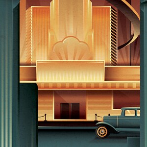 May include: A vintage car parked in front of a large building with a geometric design. The building has a large, rounded window and a sign that reads "The Grand Theater". The car is a dark blue sedan with a chrome bumper and headlights.