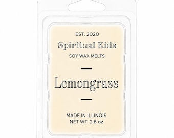 May include: A rectangular clear plastic clamshell package containing cream-colored soy wax melts. The label reads: EST. 2020, Spiritual Kids, SOY WAX MELTS, Lemongrass, MADE IN ILLINOIS, NET WT. 2.6 oz. The packaging features a hanging tab at the top.