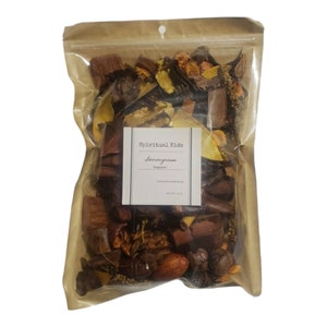 May include: A brown paper bag with a clear plastic window, filled with a variety of dried natural elements, including bark, leaves, and flowers. The bag is labeled "Spiritual Kids Lemongrass Potpourri".