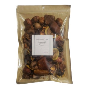 May include: A clear plastic bag filled with a variety of brown, orange, and beige potpourri pieces. The bag has a label that reads "Spiritual Kids Honeycrisp Jalapeno Potpourri".