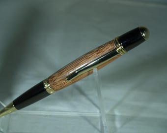 Gold and Black pen dressed in rosewood