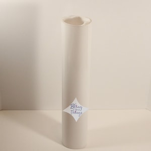 May include: A white roll of heat transfer vinyl with a diamond-shaped sticker that says "Bling Your Things".