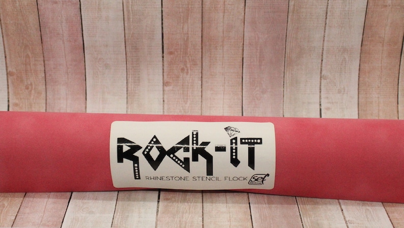 May include: A red roll of rhinestone stencil flock with a white label that says "Rock-It Rhinestone Stencil Flock Set".