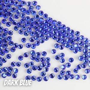May include: A scattering of dark blue rhinestones on a white background.  The rhinestones are small and round, with a slightly faceted surface.  DARK BLUE is written in white letters at the bottom of the image.