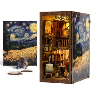 May include: A wooden 3D puzzle and a miniature diorama depicting Van Gogh's "Starry Night." The puzzle shows the painting, while the diorama features a detailed artist's studio with paintings, brushes, and a small easel. The diorama is illuminated.