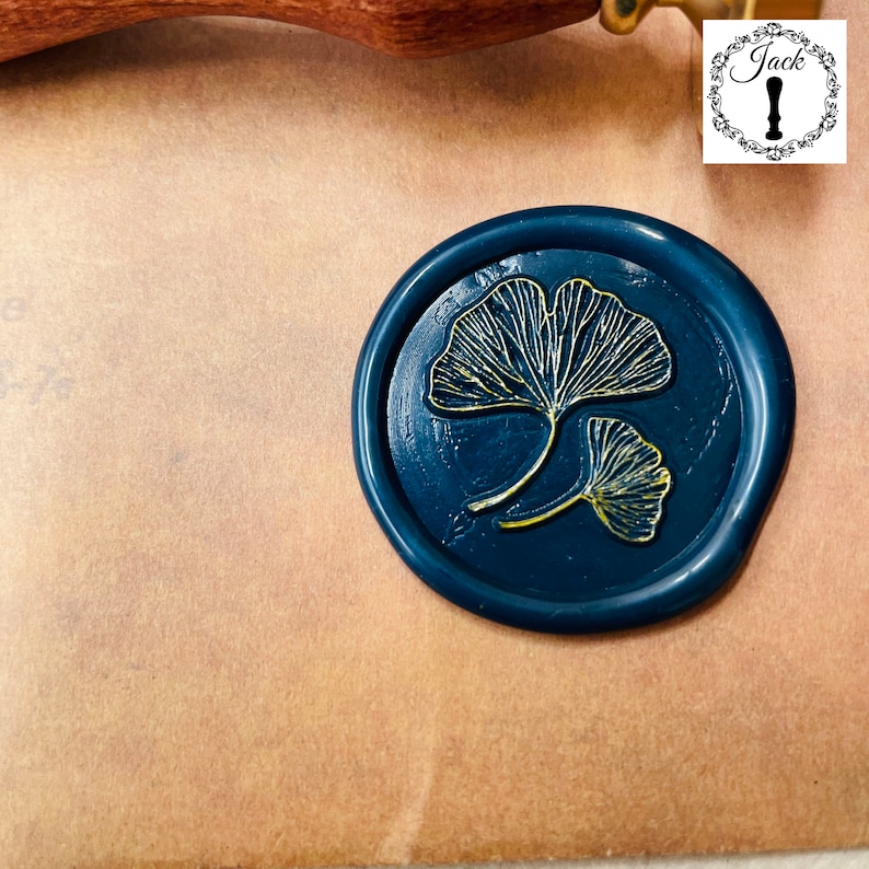 May include: A dark blue wax seal with a gold ginkgo leaf design.