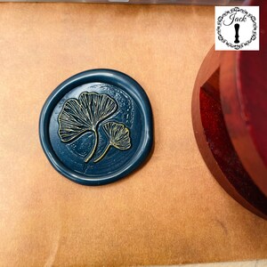 May include: A dark blue wax seal with a gold ginkgo leaf design.