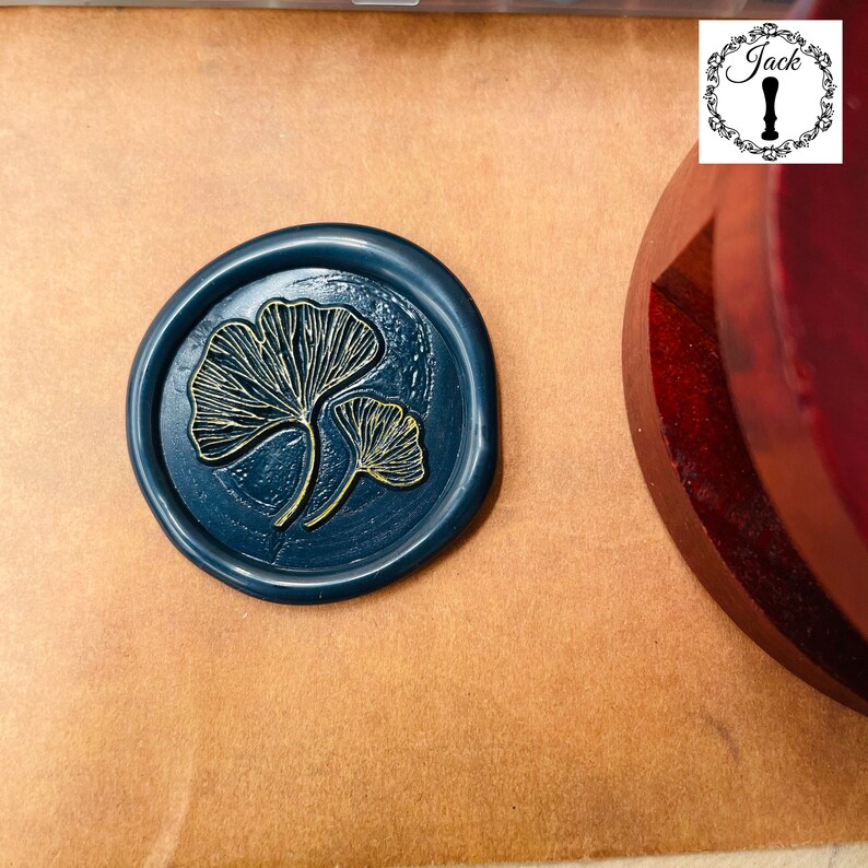 May include: A dark blue wax seal with a gold ginkgo leaf design.