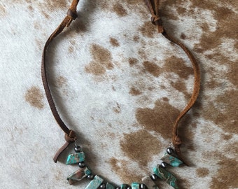 Adjustable genuine leather with faux turquoise shards and faux Navajo pearl beads.