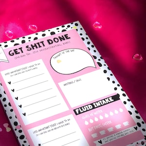 May include: A pink and black polka dot notepad with the text "Get Shit Done (For real tho...Stop procrastinating, babe)". The notepad has sections for "Very Important Stuff I Have to Do", "Less Important Stuff I Have to Do", "Thought of the Day", "Meetings/Calls", and "Fluid Intake".