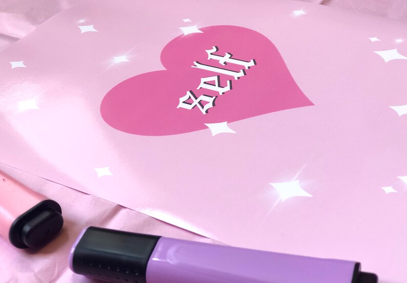 May include: Pink poster with a pink heart and the word "Self" in white gothic lettering. The background has white glitter stars.