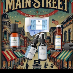 May include: A set of four Main Street Collection scented products from Magical Ears. The set includes a vanilla scented candle, a vanilla scented room spray, a vanilla scented diffuser oil, and a vanilla scented roll-on oil. The products are packaged in brown glass bottles with black labels and white text. The bottles are arranged on a vintage-style illustration of a town street.