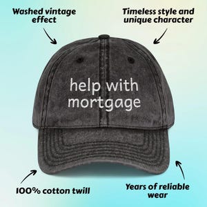 May include: A distressed black baseball cap with the phrase "help with mortgage" embroidered in white. The hat is made of 100% cotton twill and features a washed vintage effect. It has a curved brim and a classic six-panel design.