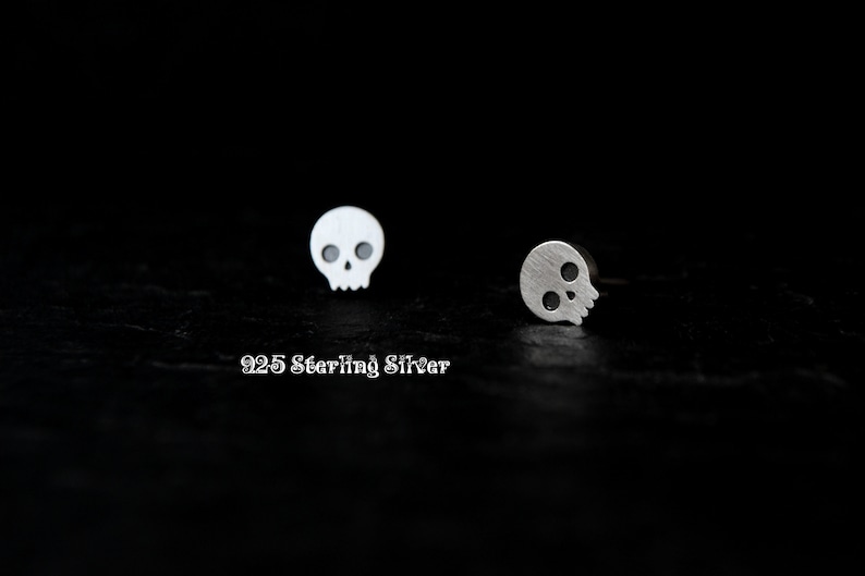 May include: A pair of silver skull stud earrings. The earrings are made of 925 sterling silver.