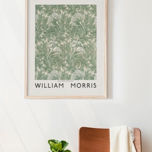 May include: A framed print of a green and white floral pattern with the text "Tulips Print (1876) by William Morris" and "WILLIAM MORRIS" below the pattern.