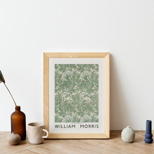 May include: A framed print with a green and white floral pattern. The print is titled "William Morris".