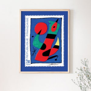 May include: A framed poster of a colorful abstract painting on a blue background. The painting features a red, green, and black abstract figure with a yellow detail. The poster has a stamp design with the text "REPUBLIQUE FRANCAISE" and "200 POSTES".