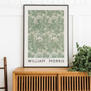 May include: A framed print of a green and white floral pattern with the text "William Morris" at the bottom. The print is on a light beige background.
